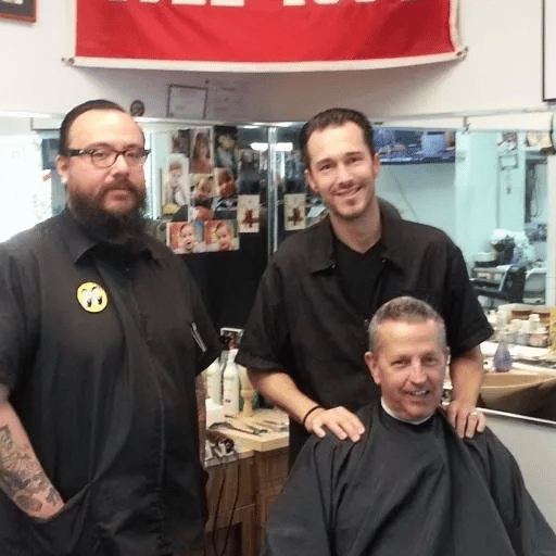 Barber shop scene with three barbers posing together